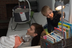 Toddler getting book to read with dad