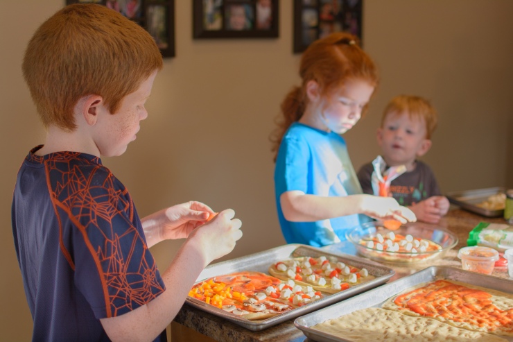 Documentary photograph of children making pizza