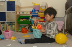 Preschooler with bucket of tools
